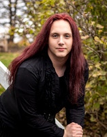 A red headed young trans women poses in her Senior Portraits