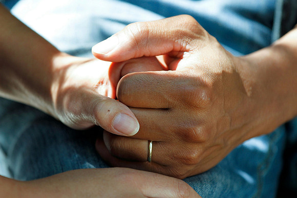 Two hands holding in time of needed support