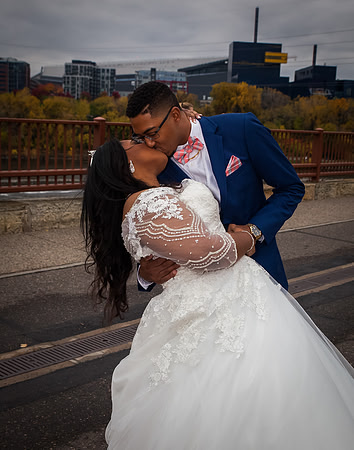 A couple kisses on the Stone Arch Bridge