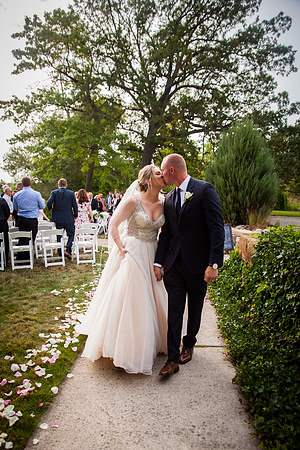 A couple kisses shortly after tying the knot in Lansing Michigan
